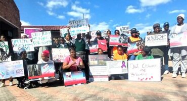 A group of people holding signs and holding up signs.