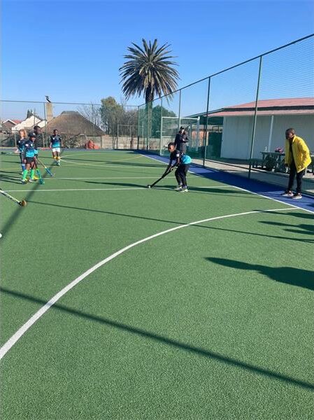 A group of people playing soccer on a court.