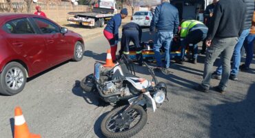 A motorcycle is being loaded onto a truck.