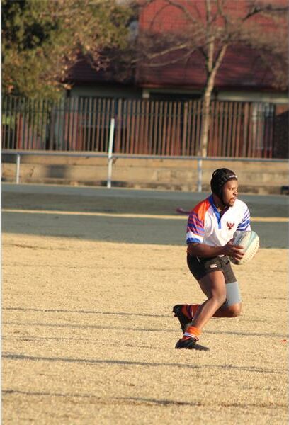 A group of people playing a game of rugby.