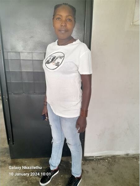 A woman wearing a white t - shirt and jeans.