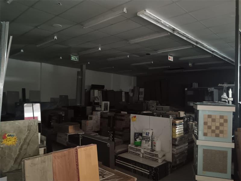 A large room with lots of furniture and appliances.