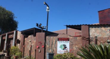A sign on a fence that says "no trespassing".