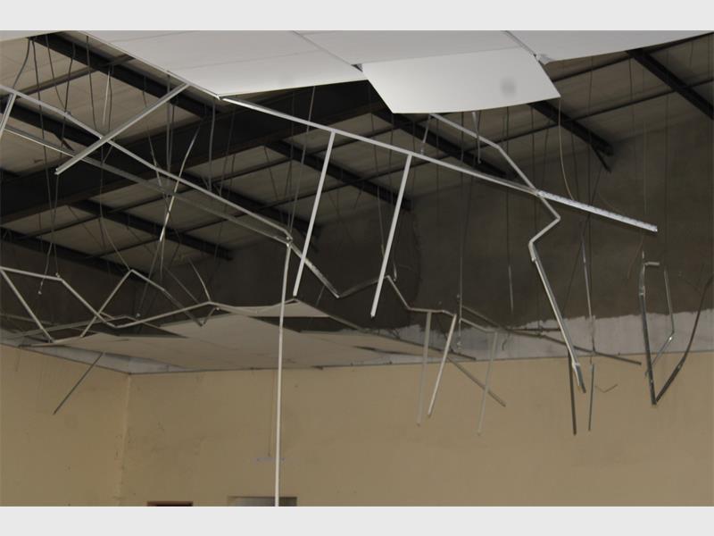 A ceiling with wires hanging from it.