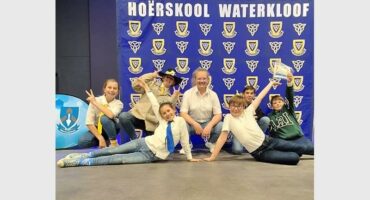 The students pose for a photo in front of the waterloof sign.