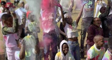 People are throwing colored powder at each other.