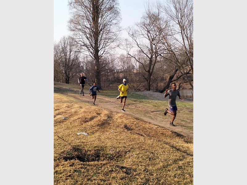 A group of people running on a path.