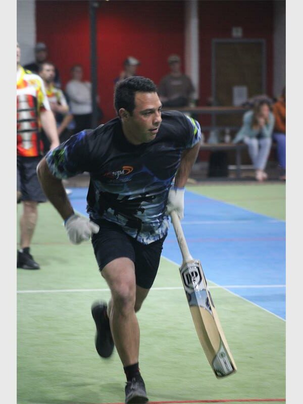 A man running with a bat on a court.