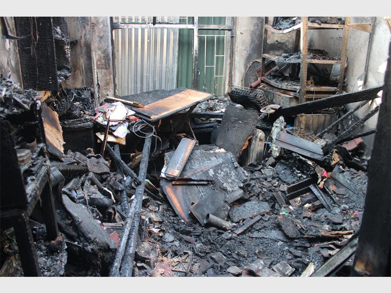A room with a lot of fire damage and debris.