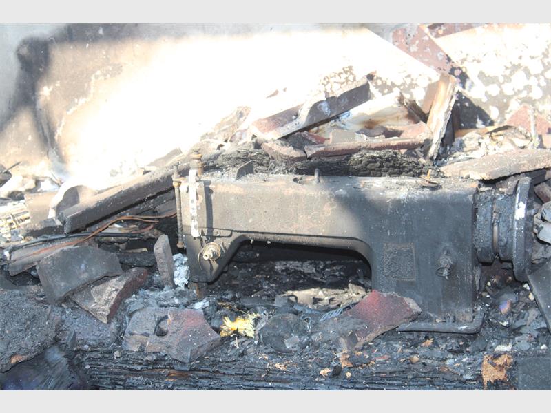 A room with a lot of fire damage and debris.
