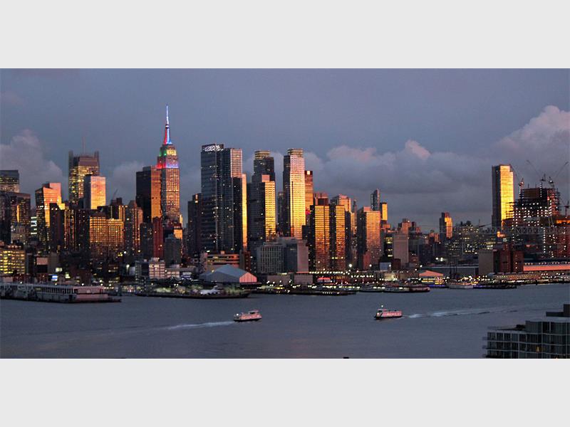 A city skyline with boats in the water.