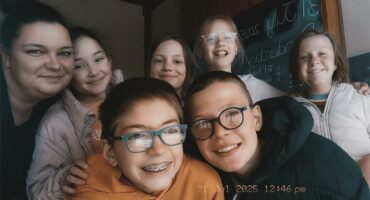 A group of children and adults posing for a photo.