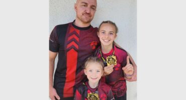 A man and two children are posing for a photo.