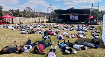 A man in a suit and tie standing at a podium.