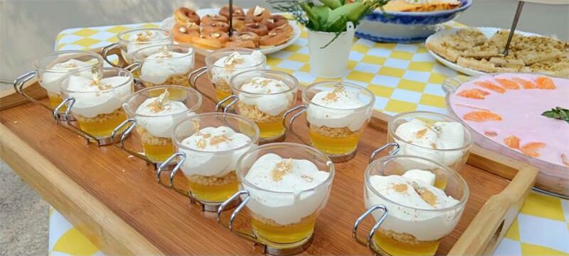 A table topped with desserts and drinks.