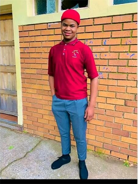 Young man with red shit and blue trousers