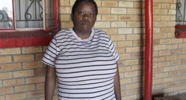 woman with big breasts wearing a striped black and white T-shirt.