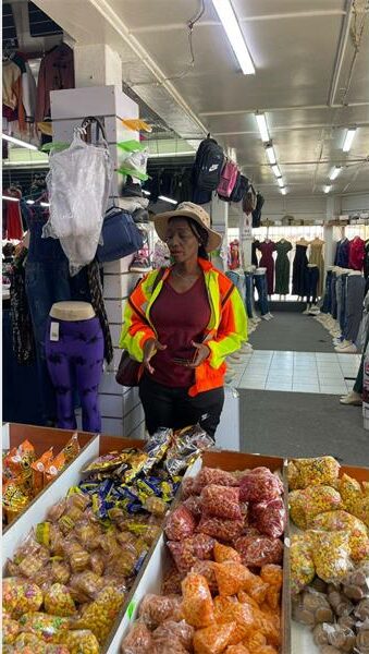 Person in safety reflector jacket in a grocery store
