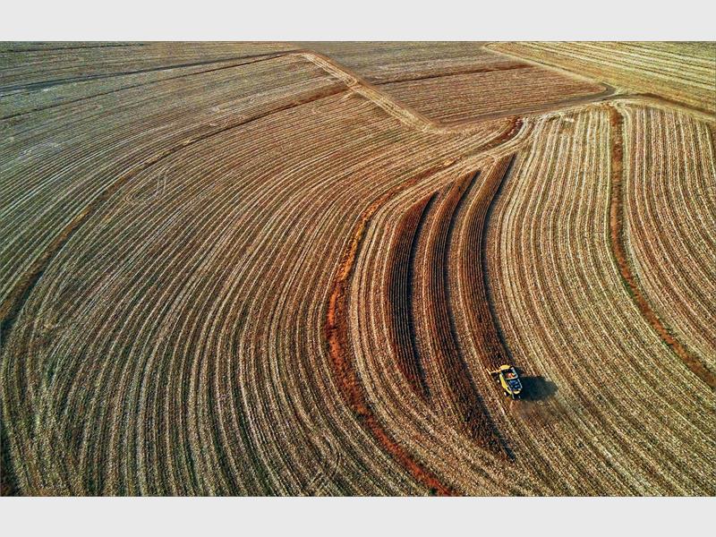 Arial photo of a field being harvested.