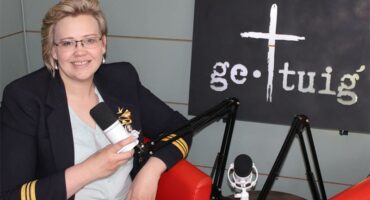 Woman with microphone hosts a podcast about faith.