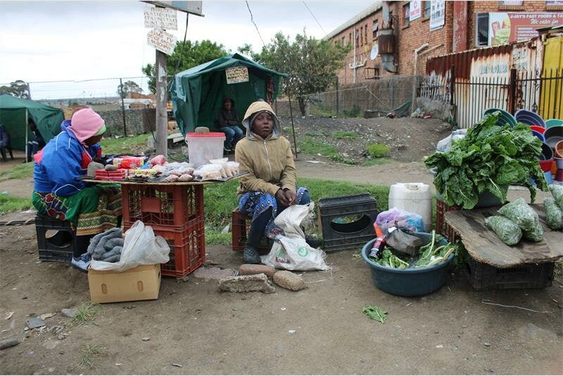 Vendors with green vegetables.