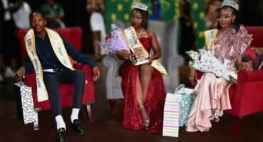 Beauty king and queens on stage.