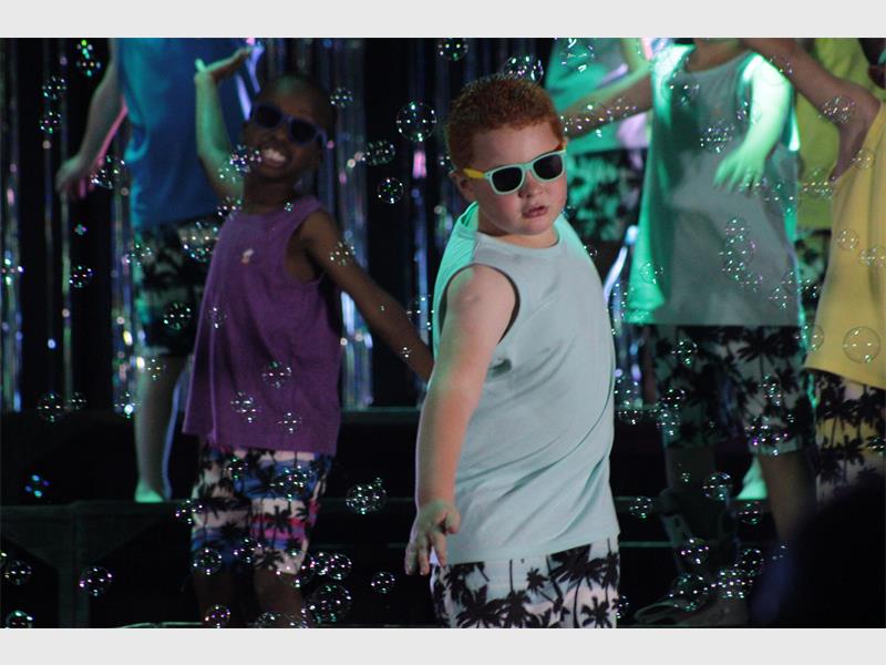 boy with sunglasses performs