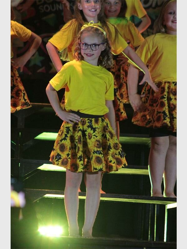 girls with sunflower skirts and yellow shirts