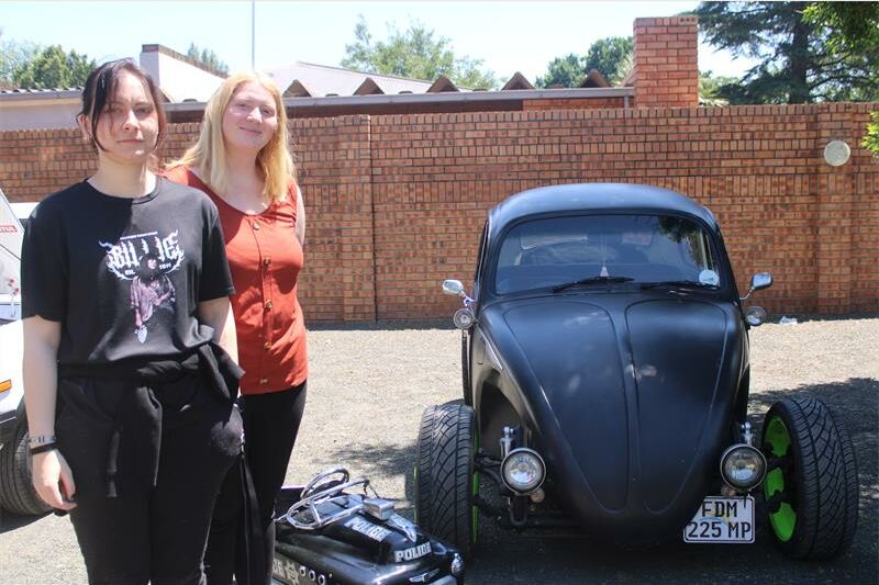 women with an antique car