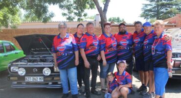 a group of people in front of vehicles on show