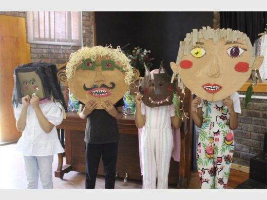 Children show off their masks.
