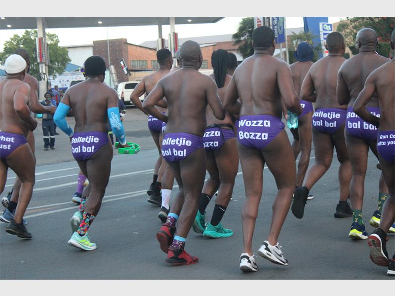 men running in speedo from behind
