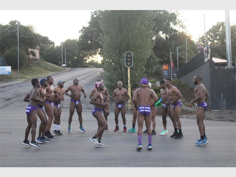 The men danced at the Wimpy robot.