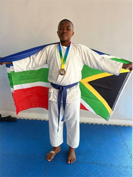 Karate student holds up SA flag
