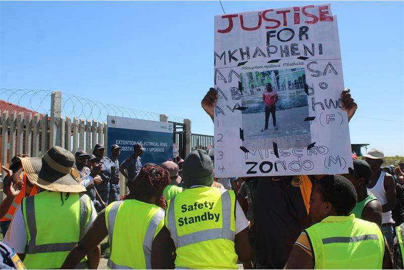A protestor hold up a sign for justice