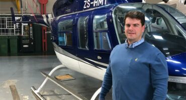 Man in front of a helicopter