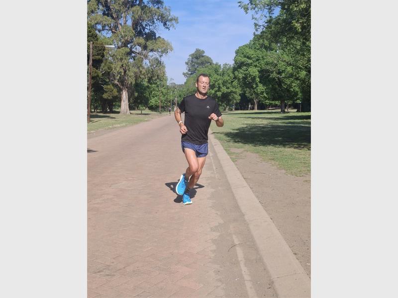 Man in black shirt sprints.