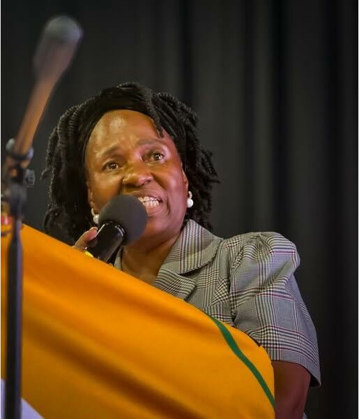 Woman behind a podium speaking into a microphone