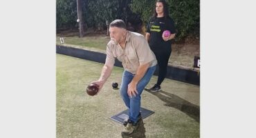 a bowls player takes aim