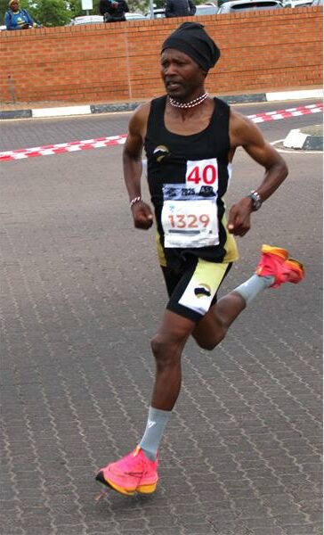 Athlete in black clothes runs road race