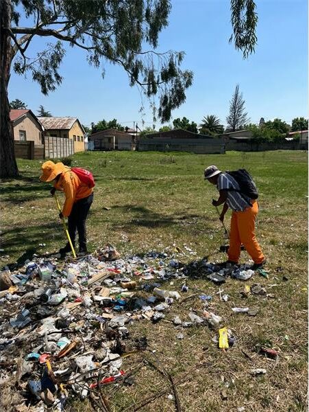 Workers clean up a park.