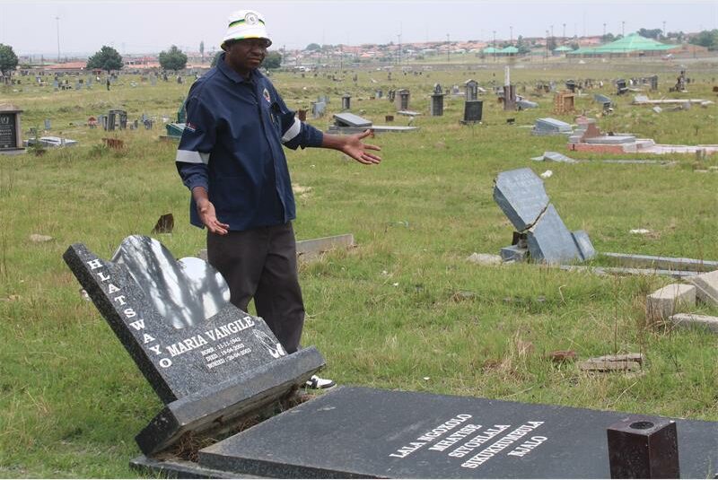 a man at a broken tombstones
