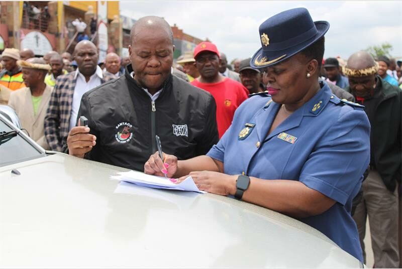 A policewoman signs a document