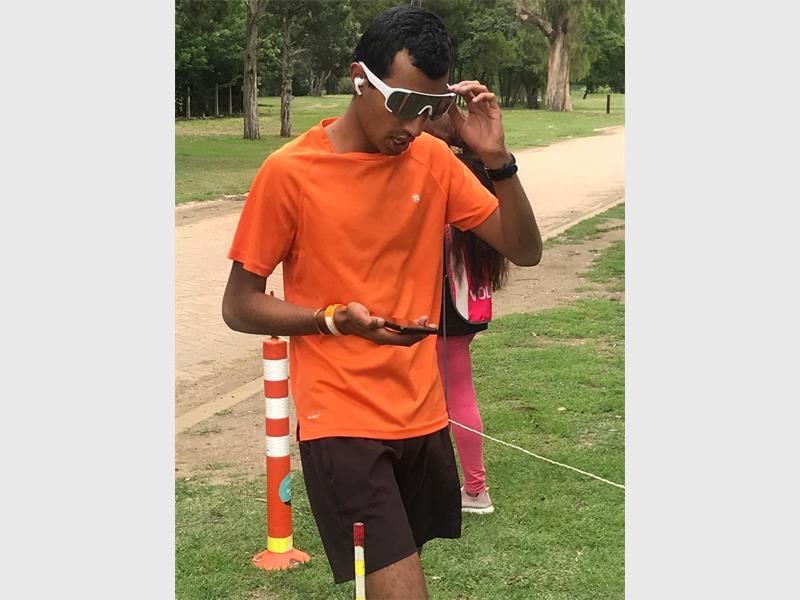 man with orange shirt and sunglasses