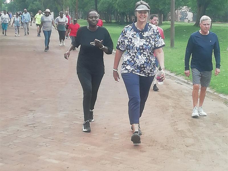 People in exercise clothes walk on cobble road