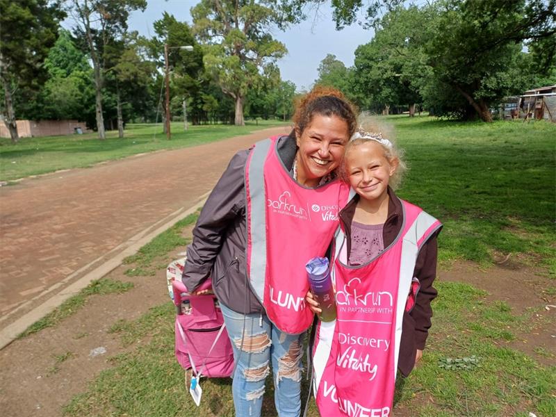 mother and daughter in pink volunteer bibss