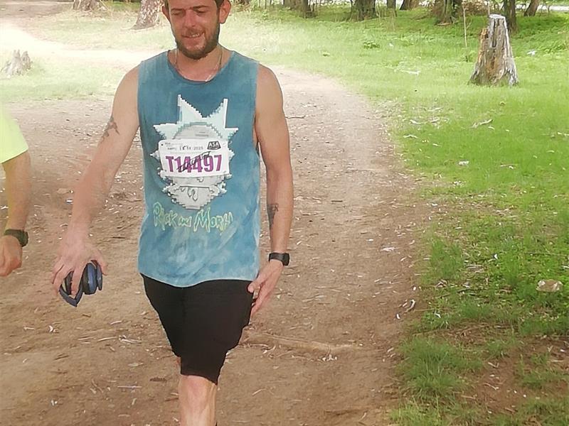 man with tank top walk in the country