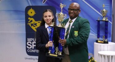 girl and man hold up trophy