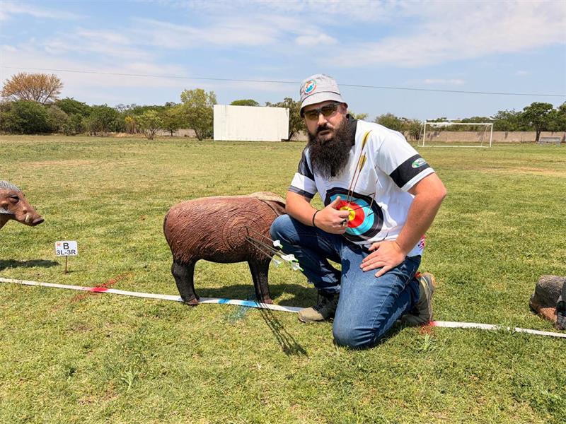 man with archery target