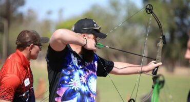 man shoots an archer's bow